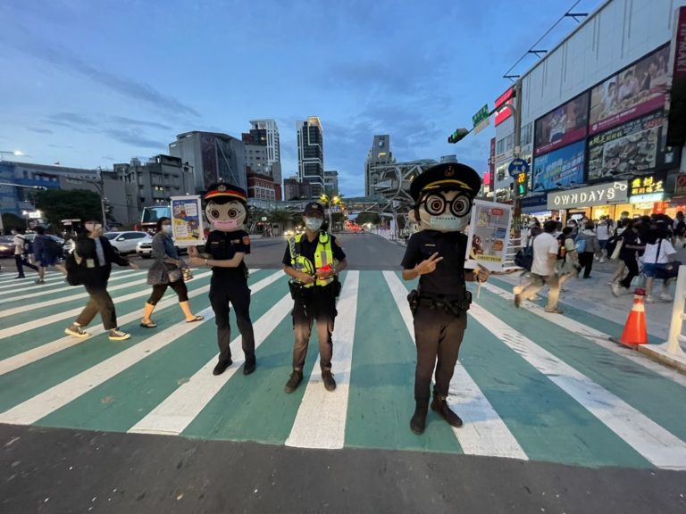 圖片說明: 府中路口辦理交通宣導快閃活動，現場有可愛的警察大頭娃娃發放交通安全宣導文宣及可愛的宣導品。(記者林艾錡翻攝)