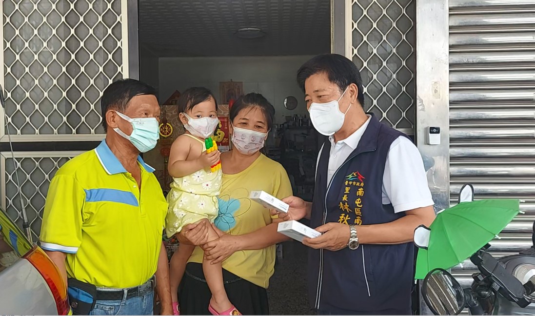 圖片說明:南屯里長林秋潭與鄰長至民眾家戶發送自己照顧2-12歲孩童快篩。(記者謝榮浤翻攝)