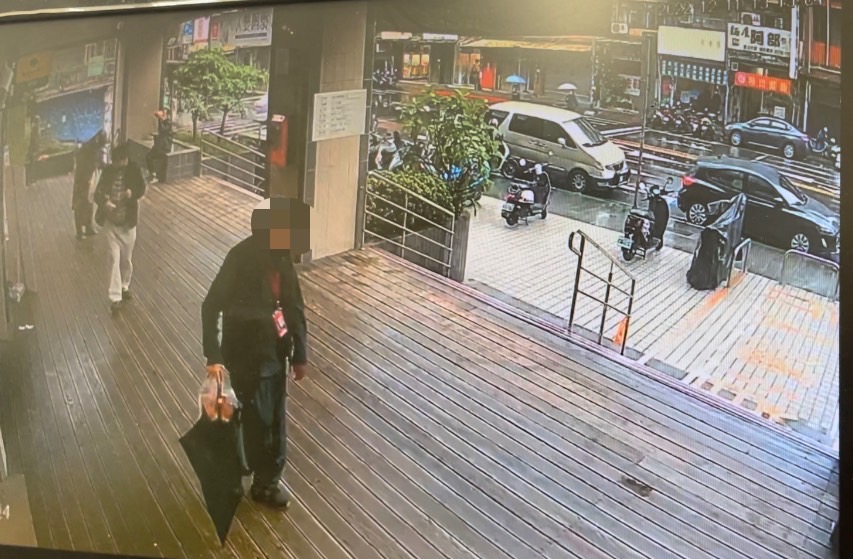 監示器畫面拍到陳姓嫌疑人竊走黑色直傘。（記者楊國域翻攝）