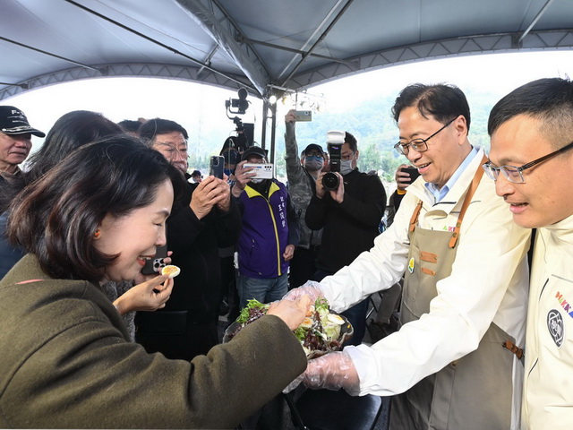 張善政巿長以在地食材製作小農沙拉,親自端到台下請貴賓品嚐。(桃園市政府提供)