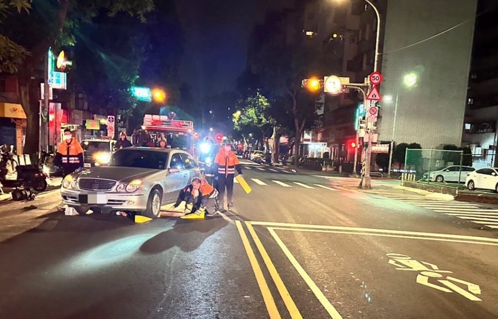 警消現場對遭輾壓車底男子進行搶救。(記者林金聖翻攝)