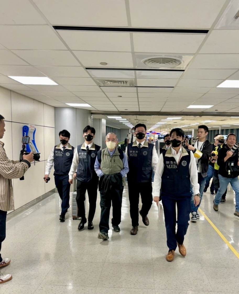 黃立雄(左三)除被控吸金被通緝，還逃漏稅7千於萬元，今早被戴銬押返台灣歸案。(記者張欽翻攝)