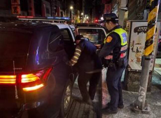 建成派出所員警攙扶老翁上車。(圖/記者戴昱弘 翻攝)