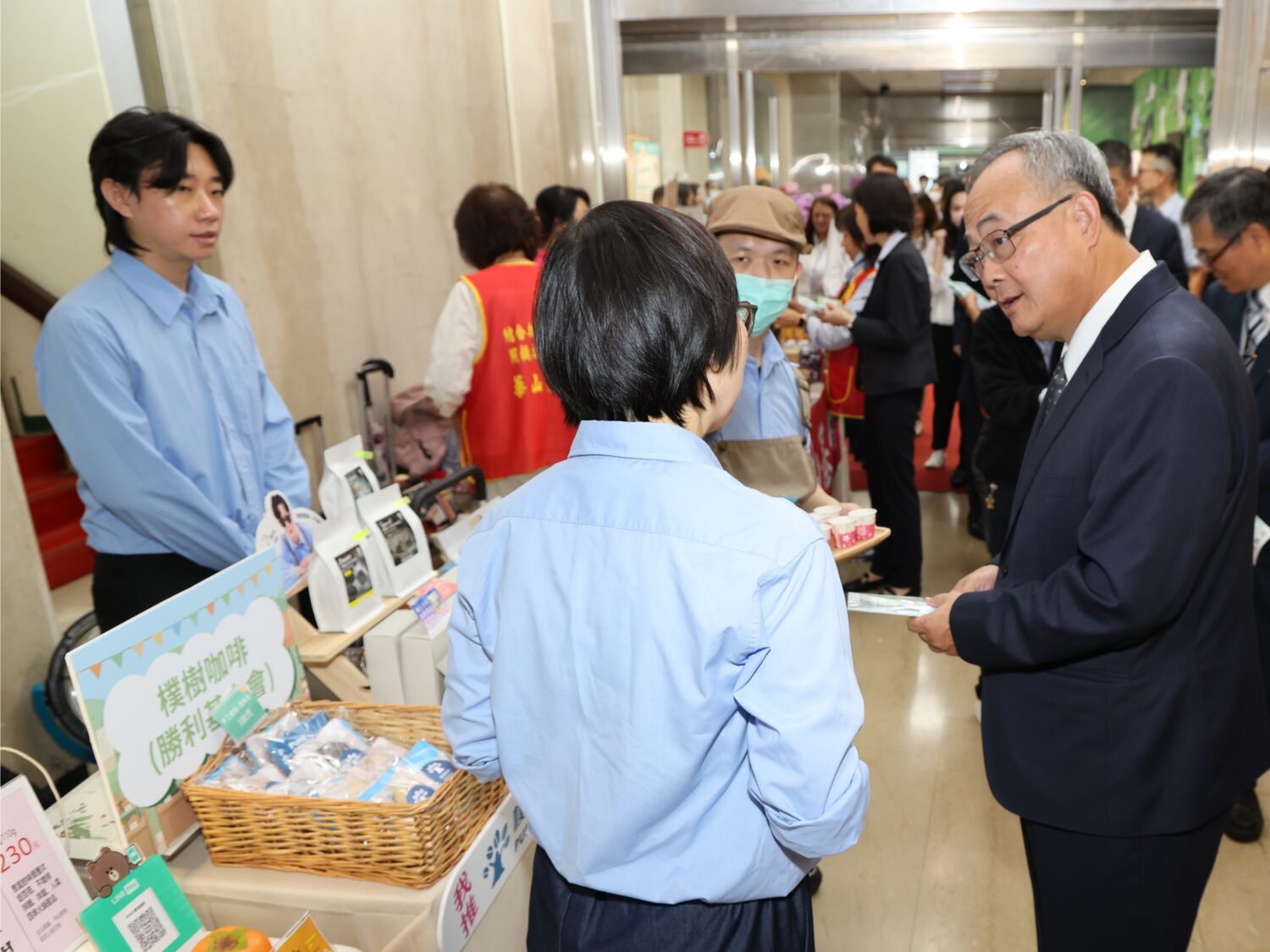 土地銀行總經理張志堅(右一)巡視公益市集攤位,選購特色商品,以行動支持社會公益及在地農業 (圖/ 記者 劉其昌 翻攝)。。